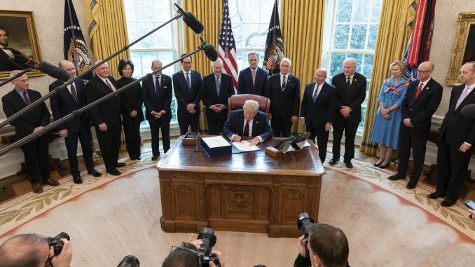 President Trump signs the CARES Act on March 27